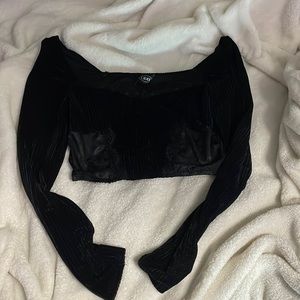 small black laced crop top with long sleeves.